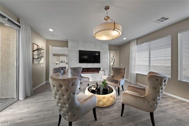 4702 Amazing View St, Las Vegas, NV 89129 - living area featuring baseboards, wood finish floors, a large fireplace, and recessed lighting