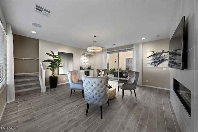 4702 Amazing View St, Las Vegas, NV 89129 - dining space with baseboards, wood finished floors, a glass covered fireplace, and recessed lighting