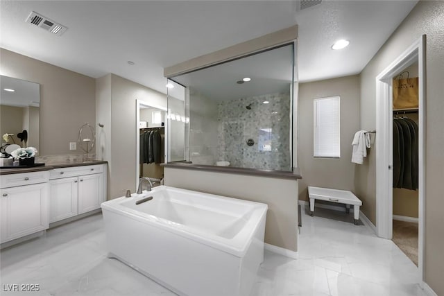 4702 Amazing View St, Las Vegas, NV 89129 - full bath featuring vanity, a spacious closet, a walk in shower, marble finish flooring, and a garden tub