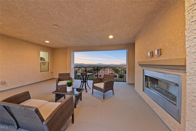 4702 Amazing View St, Las Vegas, NV 89129 - view of patio / terrace with a balcony, a mountain view, and an outdoor living space with a fireplace