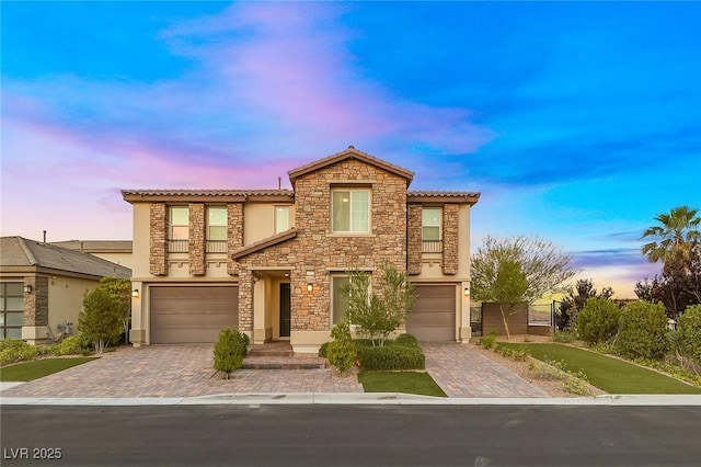 4702 Amazing View St, Las Vegas, NV 89129 - view of front of house with decorative driveway, an attached garage, stucco siding, and stone siding