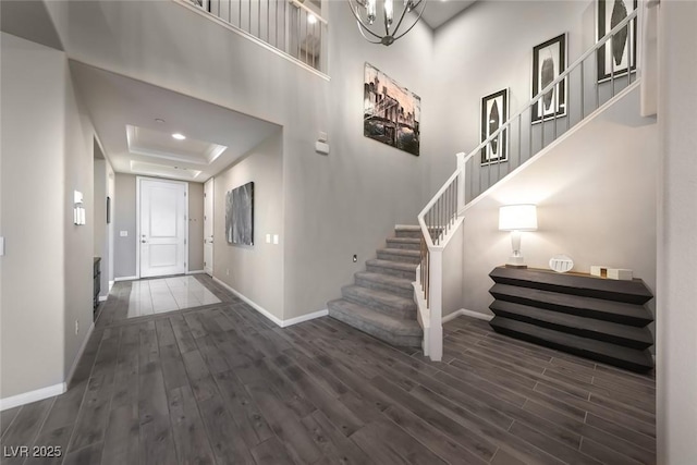 4702 Amazing View St, Las Vegas, NV 89129 - entrance foyer featuring baseboards, wood finished floors, stairs, a tray ceiling, and a high ceiling