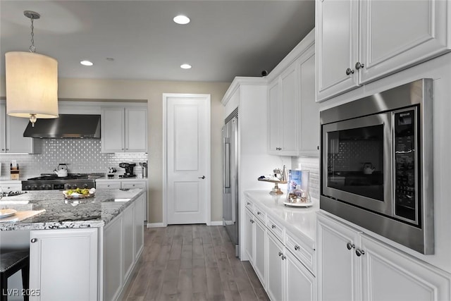 4702 Amazing View St, Las Vegas, NV 89129 - kitchen featuring appliances with stainless steel finishes, ventilation hood, white cabinetry, baseboards, and backsplash