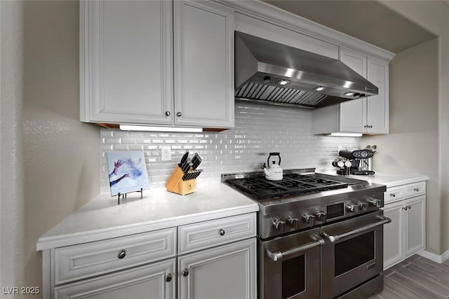 4702 Amazing View St, Las Vegas, NV 89129 - kitchen featuring double oven range, wall chimney exhaust hood, backsplash, light countertops, and white cabinets