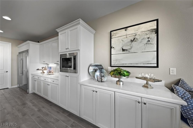 4702 Amazing View St, Las Vegas, NV 89129 - kitchen with stainless steel appliances, white cabinets, light countertops, dark wood-style flooring, and recessed lighting