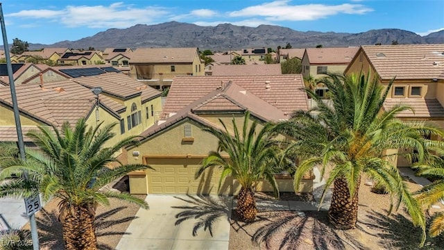 520 Blackbird Knoll Ct, North Las Vegas, NV 89084 - view of front of property with concrete driveway, stucco siding, a residential view, a mountain view, and a tiled roof