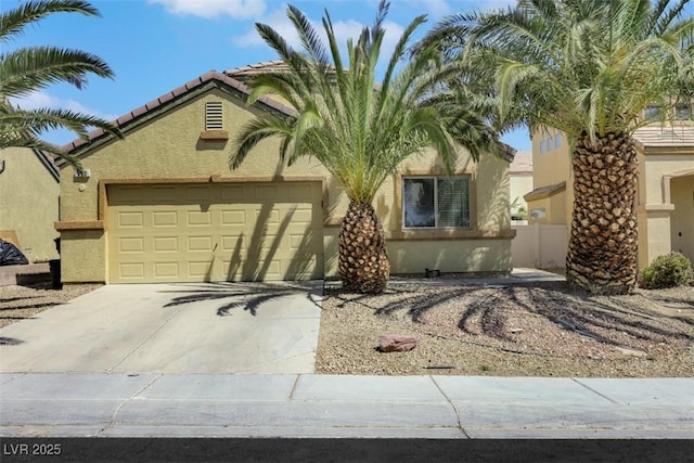 520 Blackbird Knoll Ct, North Las Vegas, NV 89084 - view of front of property featuring an attached garage, stucco siding, driveway, and a tiled roof