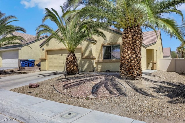 520 Blackbird Knoll Ct, North Las Vegas, NV 89084 - view of front of home with a garage, stucco siding, driveway, and a tile roof