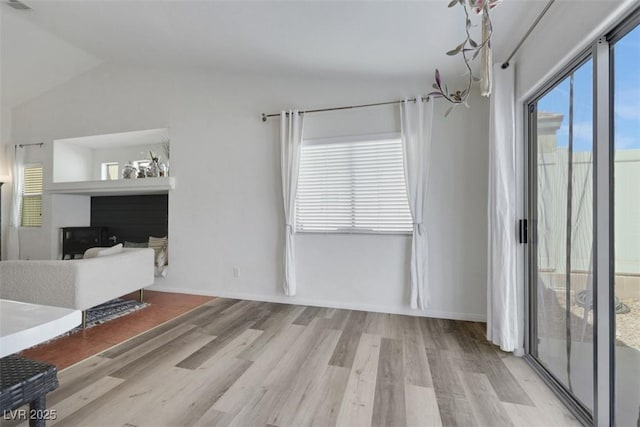 520 Blackbird Knoll Ct, North Las Vegas, NV 89084 - unfurnished living room with wood finished floors and vaulted ceiling
