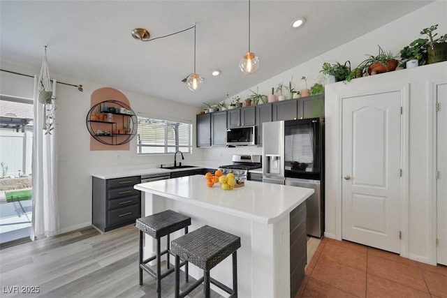 520 Blackbird Knoll Ct, North Las Vegas, NV 89084 - kitchen with appliances with stainless steel finishes, a sink, light countertops, gray cabinets, and vaulted ceiling