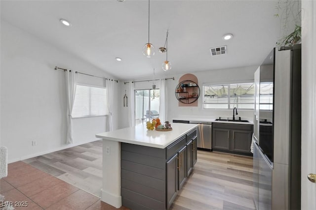 520 Blackbird Knoll Ct, North Las Vegas, NV 89084 - kitchen featuring appliances with stainless steel finishes, gray cabinets, a sink, light countertops, and a center island