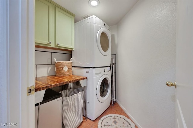 520 Blackbird Knoll Ct, North Las Vegas, NV 89084 - washroom with estacked washer and dryer, cabinet space, baseboards, and light tile patterned floors