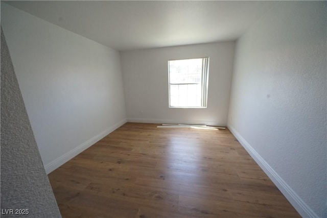 2606 S Durango Dr Unit 165, Las Vegas, NV 89117 - unfurnished room featuring wood finished floors and baseboards