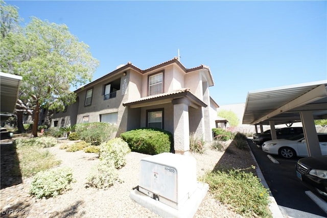 2606 S Durango Dr Unit 165, Las Vegas, NV 89117 - view of front of house featuring stucco siding, a tiled roof, and covered parking