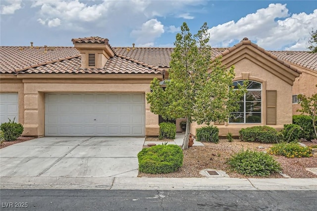 9622 Emeraude Ave, Las Vegas, NV 89147 - mediterranean / spanish-style house with driveway, a tiled roof, stucco siding, and a garage