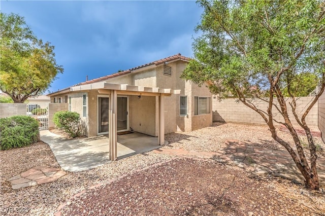 2177 Hidden Ranch Ter, Henderson, NV 89052 - back of property with stucco siding, a fenced backyard, a patio, and a tiled roof