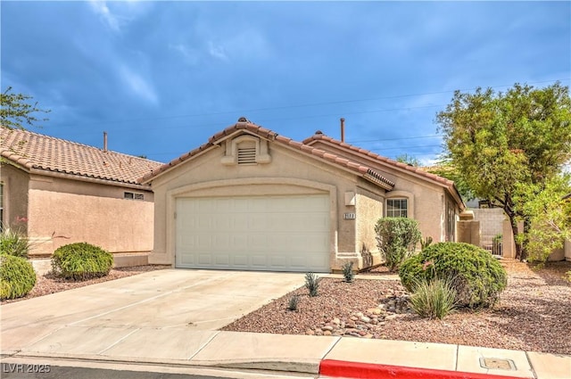 2177 Hidden Ranch Ter, Henderson, NV 89052 - mediterranean / spanish-style home featuring a garage, stucco siding, concrete driveway, and a tile roof