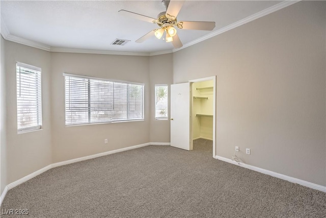 2177 Hidden Ranch Ter, Henderson, NV 89052 - unfurnished bedroom featuring carpet floors, baseboards, a walk in closet, ornamental molding, and a ceiling fan