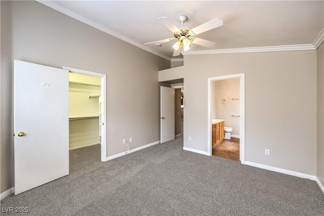 2177 Hidden Ranch Ter, Henderson, NV 89052 - unfurnished bedroom with carpet flooring, crown molding, a walk in closet, baseboards, and lofted ceiling
