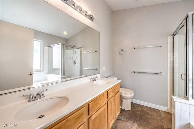 2177 Hidden Ranch Ter, Henderson, NV 89052 - bathroom featuring a shower stall, double vanity, toilet, and baseboards