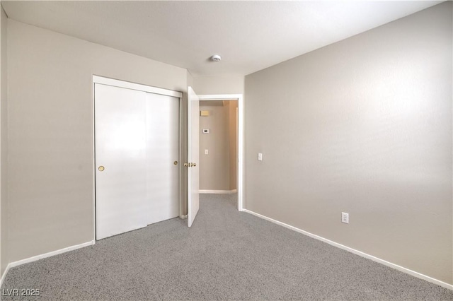 2177 Hidden Ranch Ter, Henderson, NV 89052 - unfurnished bedroom featuring light colored carpet, a closet, and baseboards