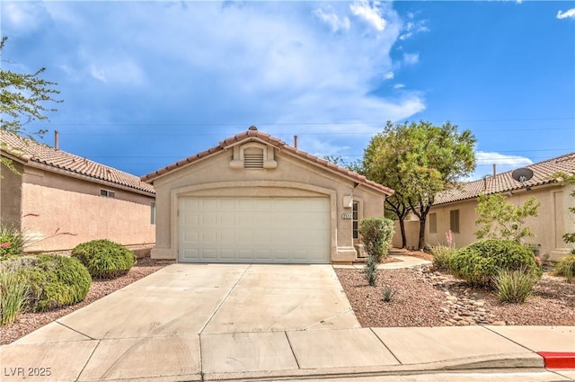 2177 Hidden Ranch Ter, Henderson, NV 89052 - mediterranean / spanish-style house with driveway, an attached garage, stucco siding, and a tiled roof