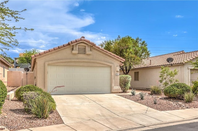 2177 Hidden Ranch Ter, Henderson, NV 89052 - view of front of home with a garage, stucco siding, a tiled roof, and concrete driveway