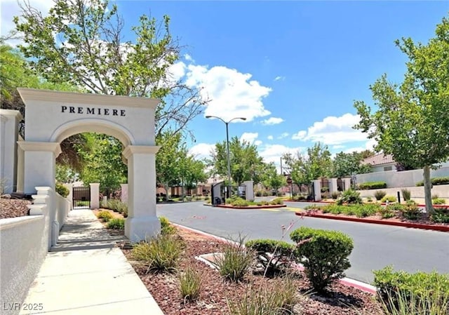 2177 Hidden Ranch Ter, Henderson, NV 89052 - view of asphalt road featuring curbs, sidewalks, street lights, and a gate