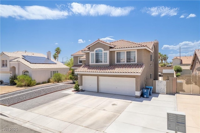 747 Canyon Crest Dr, Las Vegas, NV 89123 - mediterranean / spanish home with stucco siding, a tile roof, a gate, an attached garage, and concrete driveway