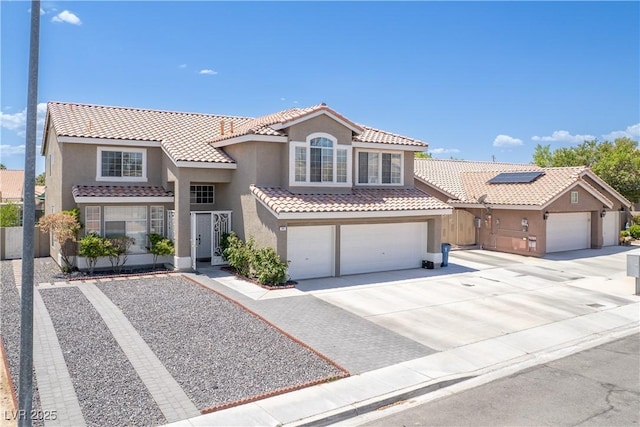747 Canyon Crest Dr, Las Vegas, NV 89123 - mediterranean / spanish-style house featuring stucco siding, a tiled roof, driveway, and an attached garage