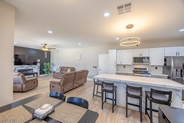 747 Canyon Crest Dr, Las Vegas, NV 89123 - dining room with light wood-style flooring, recessed lighting, ceiling fan, and baseboards