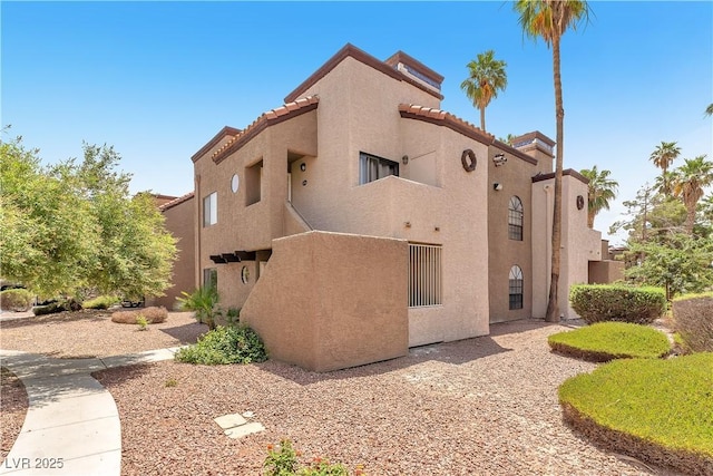 2964 Juniper Hills Blvd Unit 104, Las Vegas, NV 89142 - view of property exterior featuring stucco siding and a tiled roof
