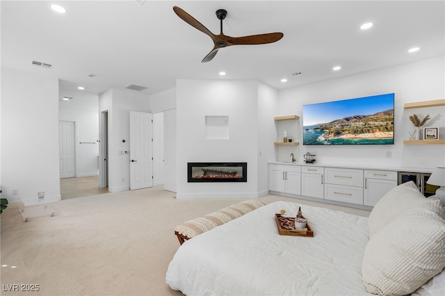 5225 Villa Dante Ave, Las Vegas, NV 89141 - living room with ceiling fan, recessed lighting, a glass covered fireplace, and light colored carpet