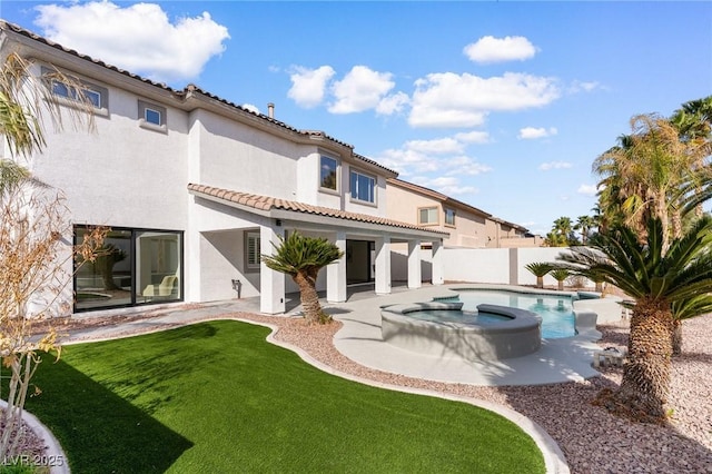 5225 Villa Dante Ave, Las Vegas, NV 89141 - back of property featuring an in-ground hot tub, stucco siding, a tile roof, and a patio area