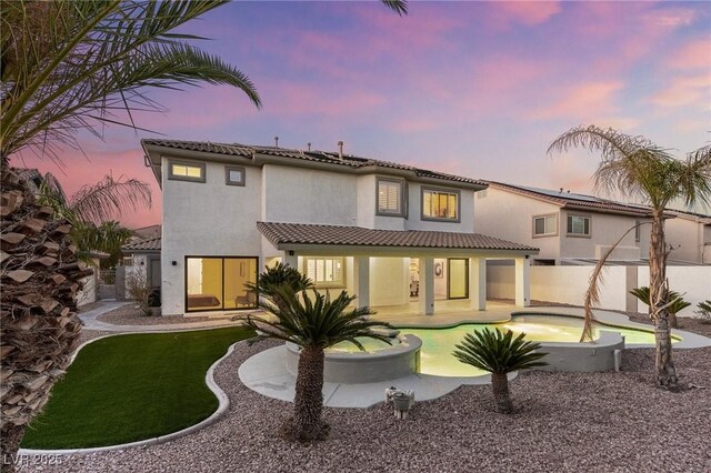 5225 Villa Dante Ave, Las Vegas, NV 89141 - back of property with stucco siding, a tile roof, a patio area, and a pool with connected hot tub