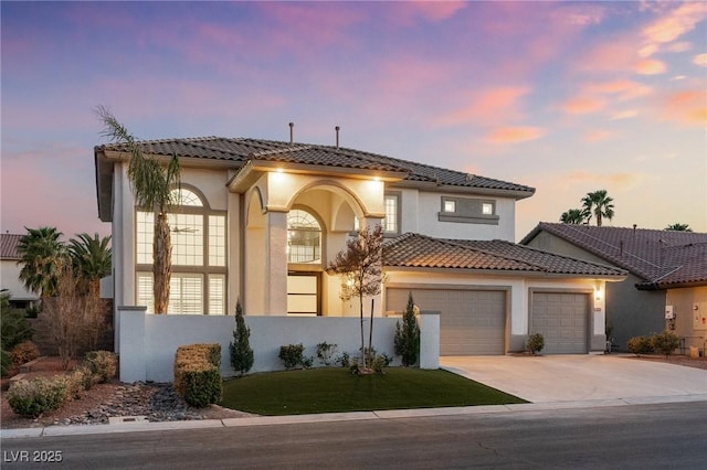 5225 Villa Dante Ave, Las Vegas, NV 89141 - mediterranean / spanish house featuring concrete driveway, stucco siding, an attached garage, and a tile roof