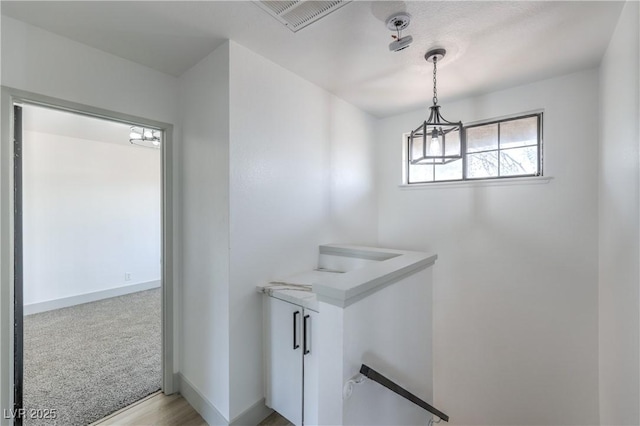 1805 Amboy Dr, Las Vegas, NV 89108 - hall featuring an upstairs landing and a chandelier