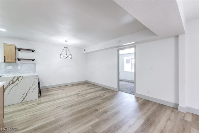 1805 Amboy Dr, Las Vegas, NV 89108 - unfurnished living room with light wood finished floors and a chandelier
