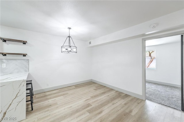 1805 Amboy Dr, Las Vegas, NV 89108 - unfurnished dining area featuring light wood finished floors and a chandelier