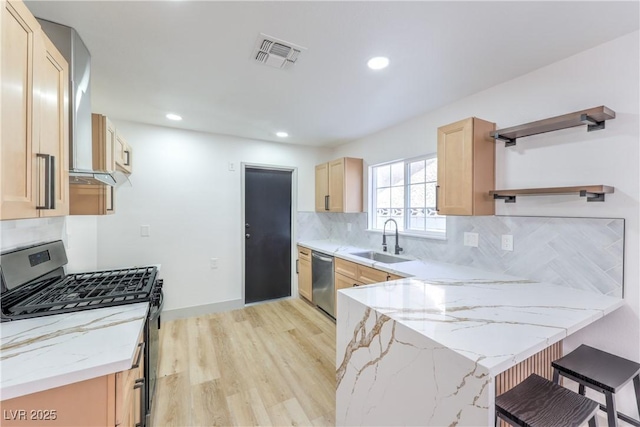 1805 Amboy Dr, Las Vegas, NV 89108 - kitchen featuring stainless steel appliances, open shelves, a peninsula, light stone countertops, and recessed lighting