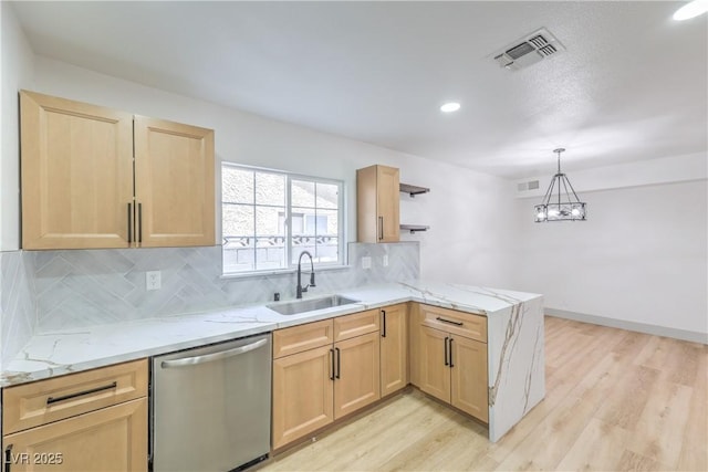 1805 Amboy Dr, Las Vegas, NV 89108 - kitchen with stainless steel dishwasher, light brown cabinets, a peninsula, light wood-type flooring, and tasteful backsplash