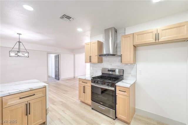 1805 Amboy Dr, Las Vegas, NV 89108 - kitchen with gas range, wall chimney exhaust hood, light brown cabinets, decorative backsplash, and light wood-type flooring