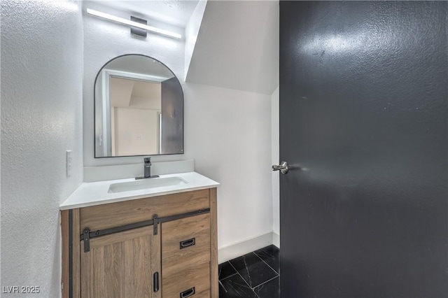 1805 Amboy Dr, Las Vegas, NV 89108 - bathroom with vanity, marble finish flooring, and a textured wall