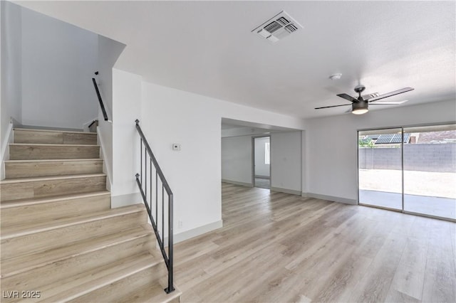1805 Amboy Dr, Las Vegas, NV 89108 - unfurnished living room with ceiling fan, stairway, and light wood-type flooring