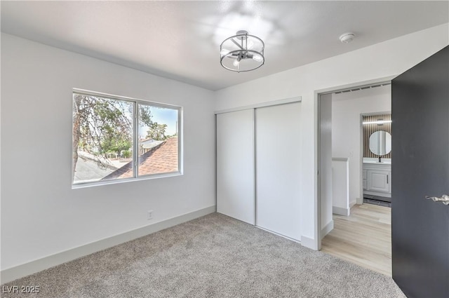 1805 Amboy Dr, Las Vegas, NV 89108 - unfurnished bedroom with a chandelier, a closet, and light carpet