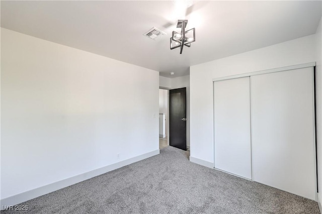 1805 Amboy Dr, Las Vegas, NV 89108 - unfurnished bedroom featuring carpet, a closet, and a chandelier