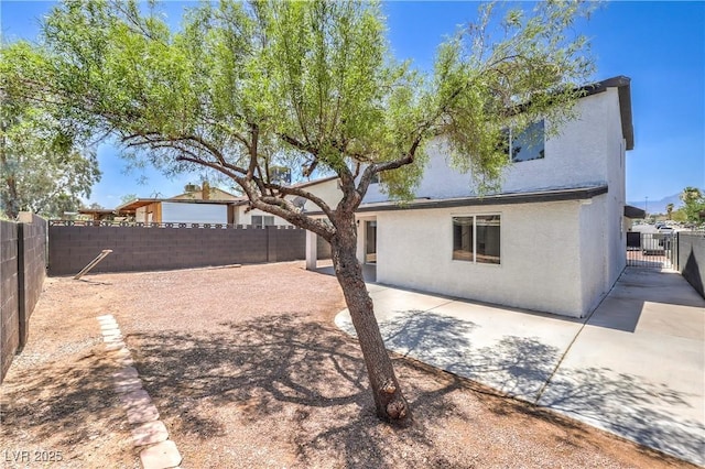 1805 Amboy Dr, Las Vegas, NV 89108 - back of house with a fenced backyard, a patio area, and stucco siding