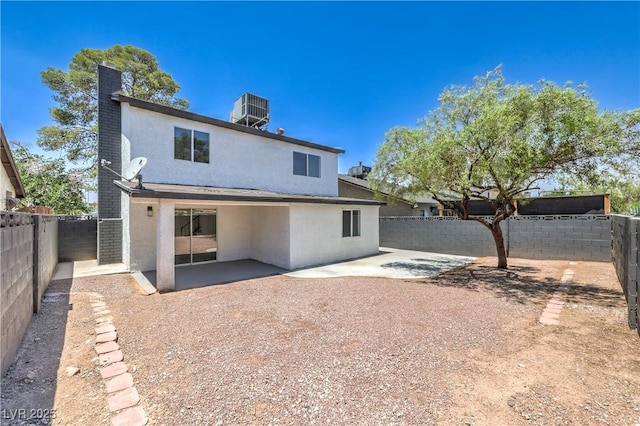 1805 Amboy Dr, Las Vegas, NV 89108 - rear view of house featuring stucco siding, a patio, a fenced backyard, and a chimney
