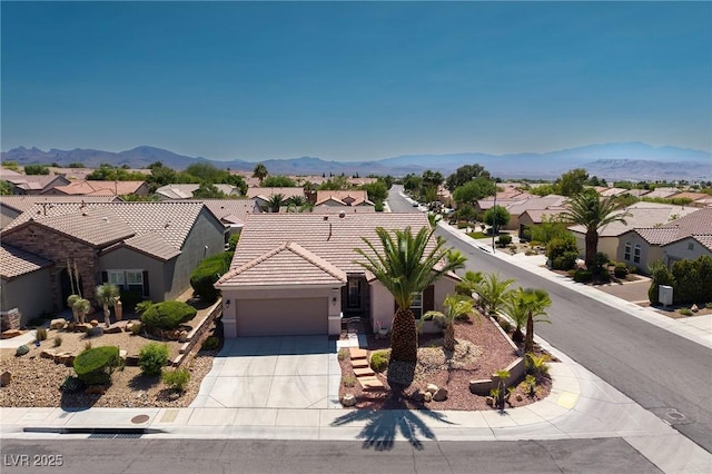 2221 River Grove Dr, Henderson, NV 89044 - view of front of house featuring a residential view, a garage, driveway, and a mountain view