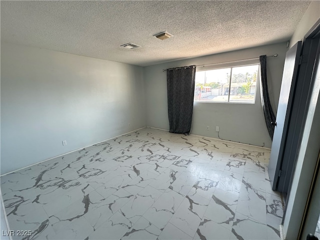 1304 Bonita Ave, Las Vegas, NV 89104 - unfurnished room with light marble finish flooring and a textured ceiling